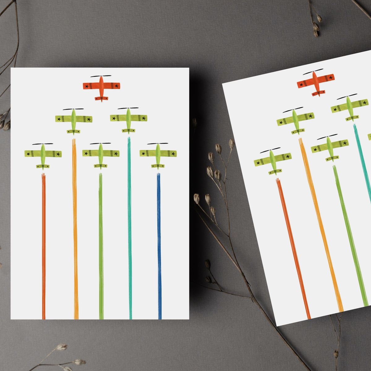 Card set with one repeating design of aircraft in formation over vertical multicolored smoke streams.