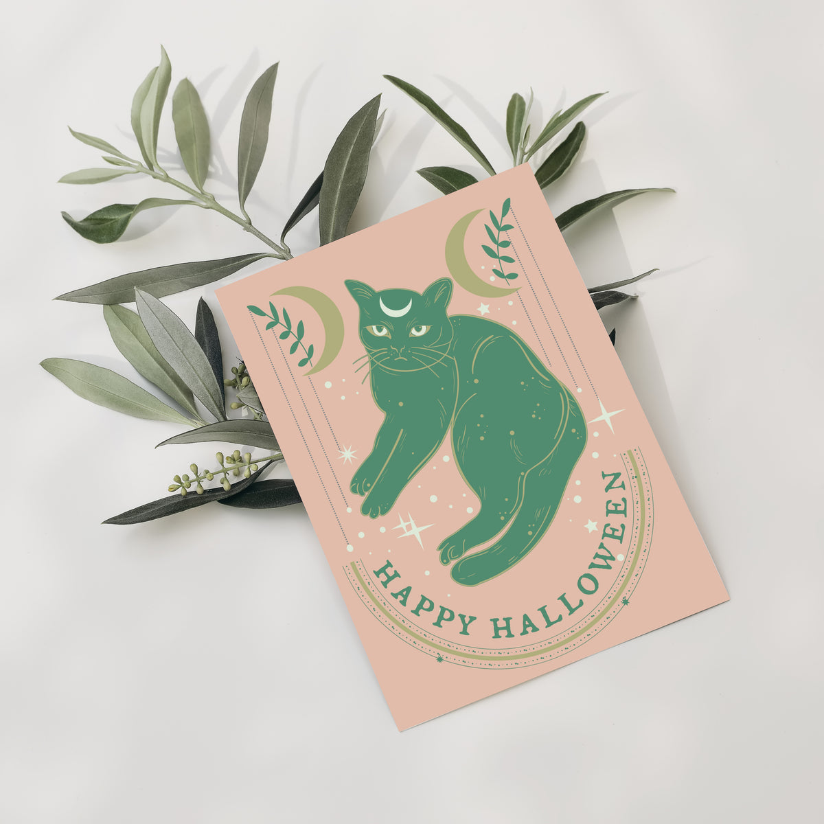 Card Halloween set with green and cream illustrations of a cat, crescent moons, and stars.