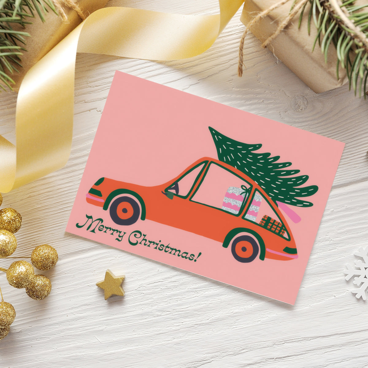 Blush pink Christmas cards with red-orange and hot pink vehicles, dark green outlines, 6 cards per design.