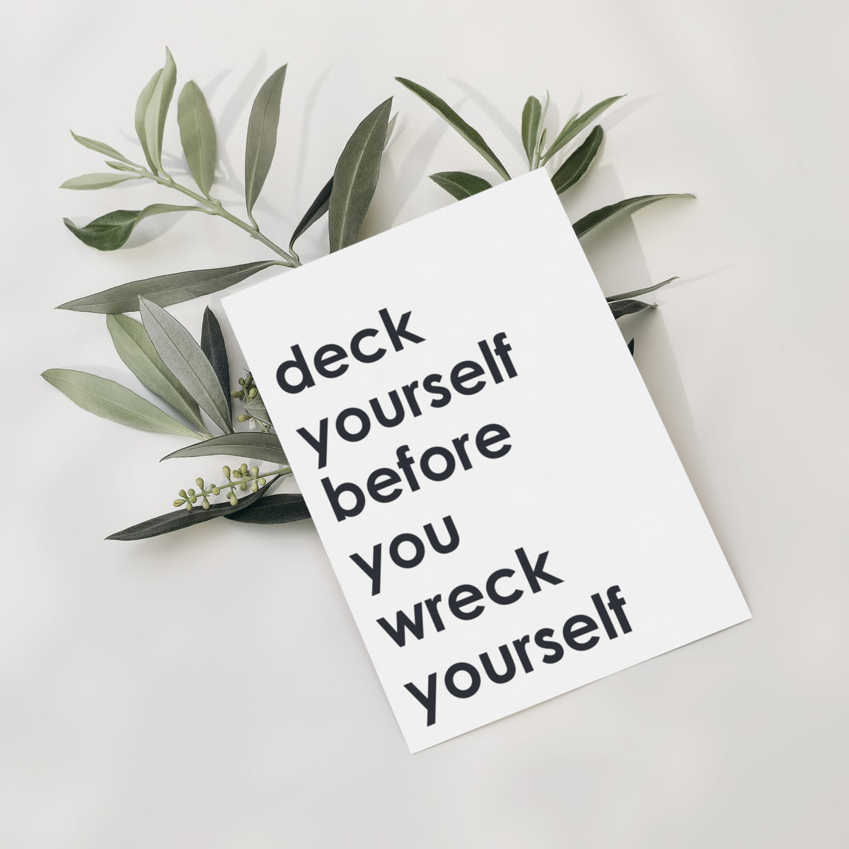 Holiday cards with humorous text printed in bold black lettering on white cardstock.