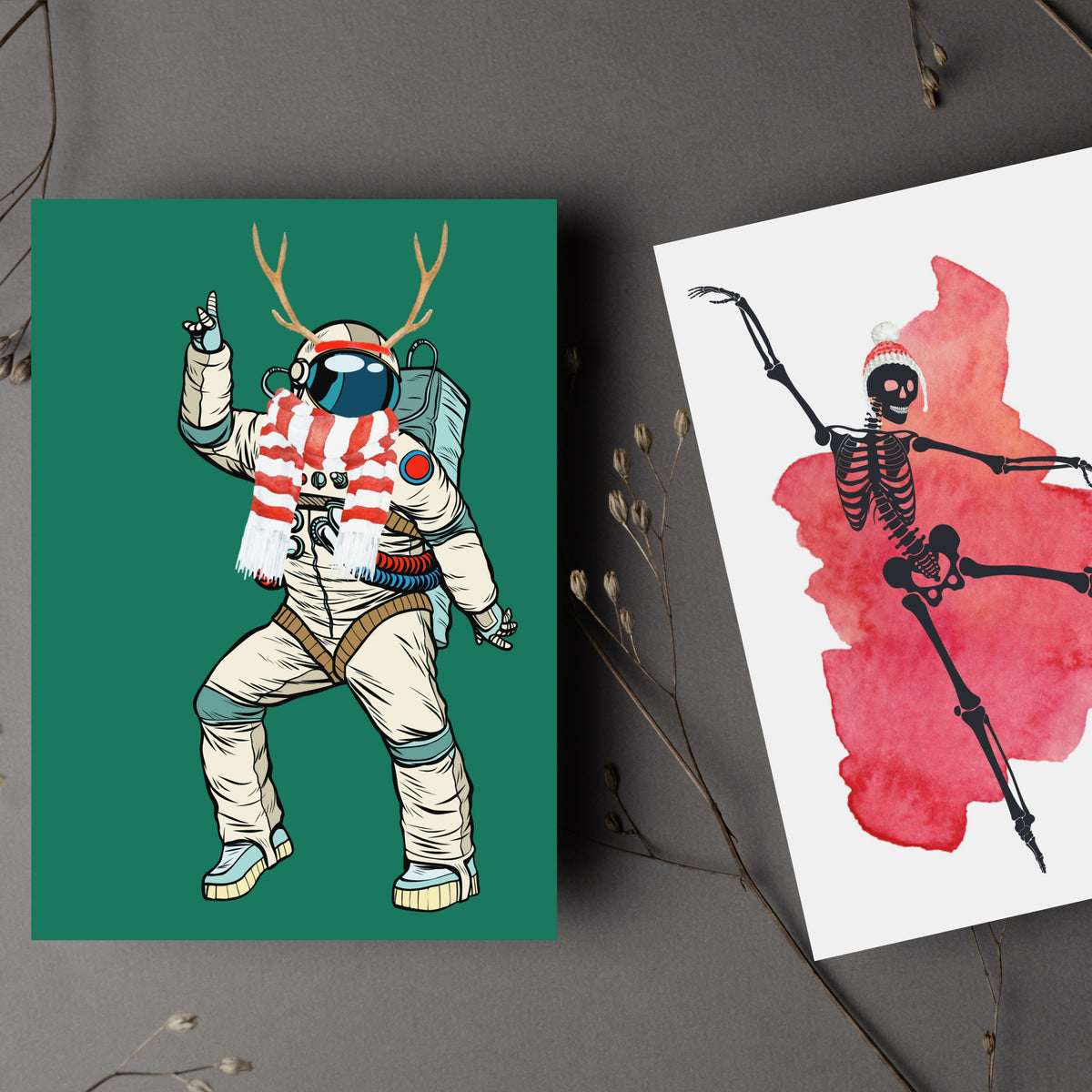 Set of 24 kids' Christmas cards with dancing skeleton designs in ballet poses wearing Santa hats over watercolor splashes.