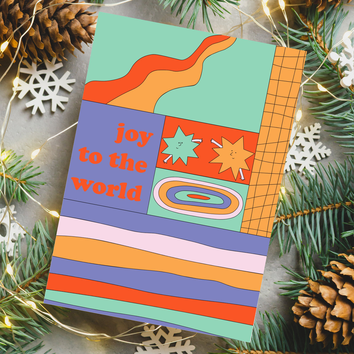 Folded card set featuring colorful patchwork grid layouts with block lettering holiday phrases.