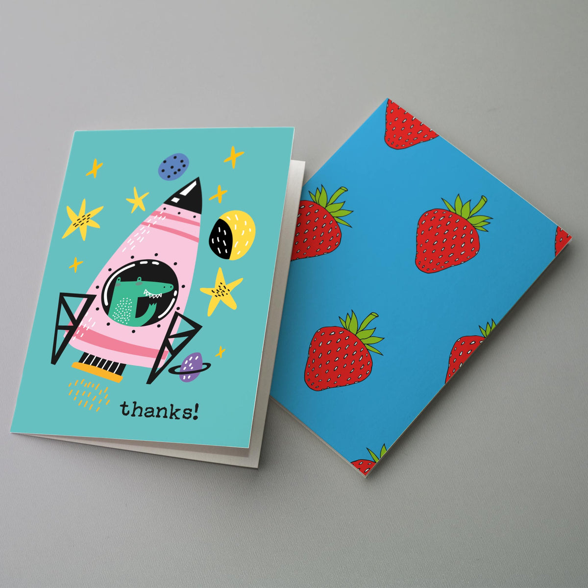 Set of 24 cards including designs with a rainbow arch, a flower-crown cat, a leopard-spot cat, and a strawberry pattern.