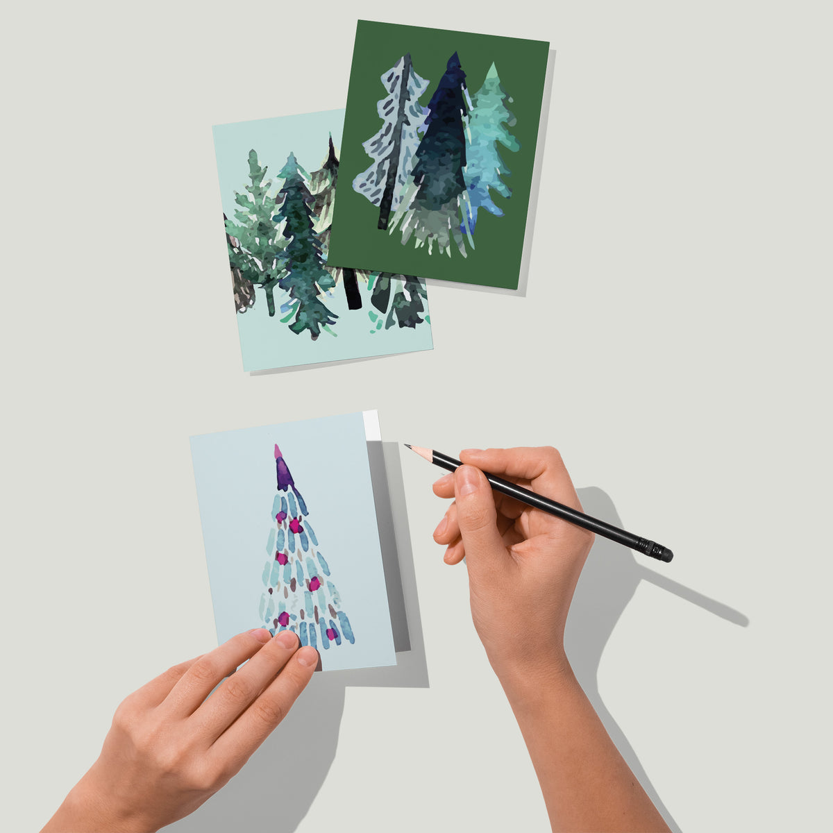 Christmas card set of 24 with abstract tree shapes on dark and pastel solid backgrounds.