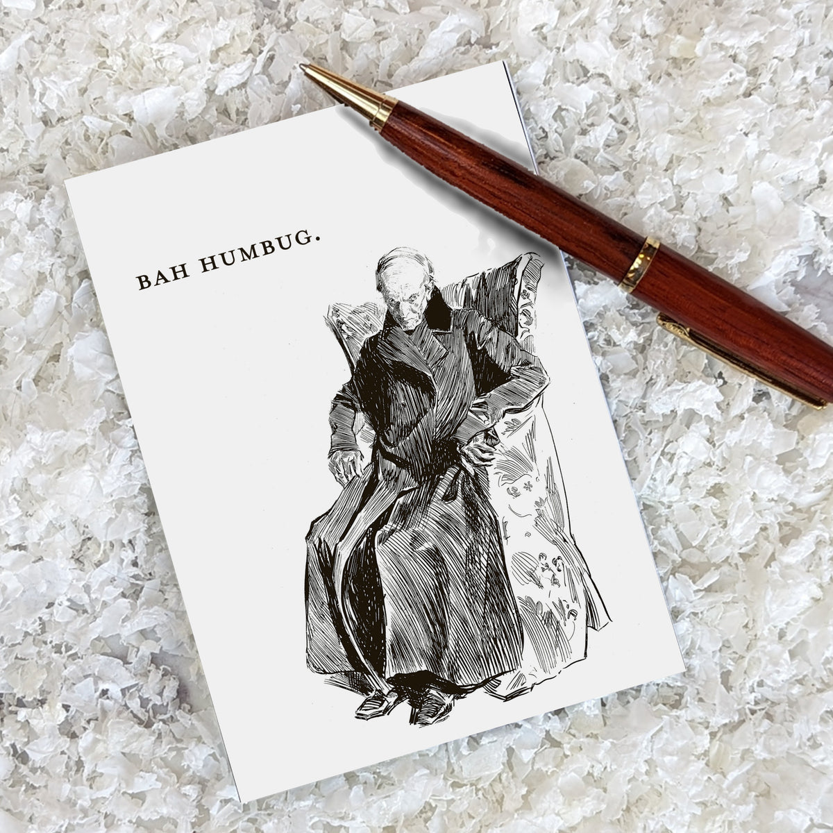 Set of 24 identical Christmas cards showing a thin, balding elderly man slumped in an armchair, black ink on white.