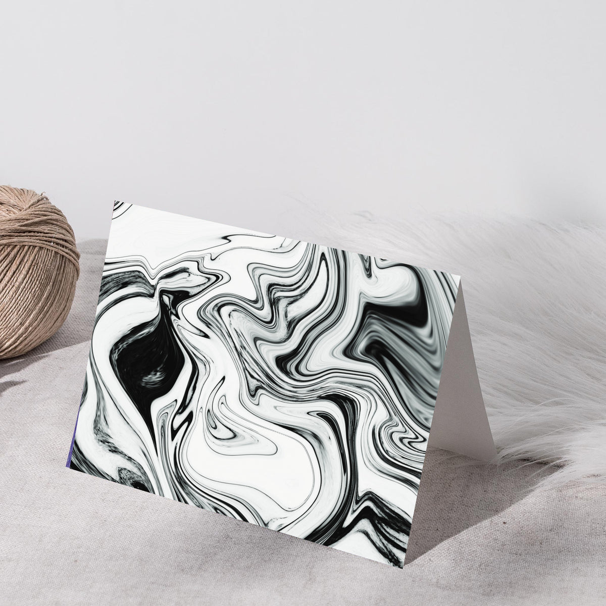 Full-bleed marbled note cards with fluid sweeping curves in black, mid-gray, and white.