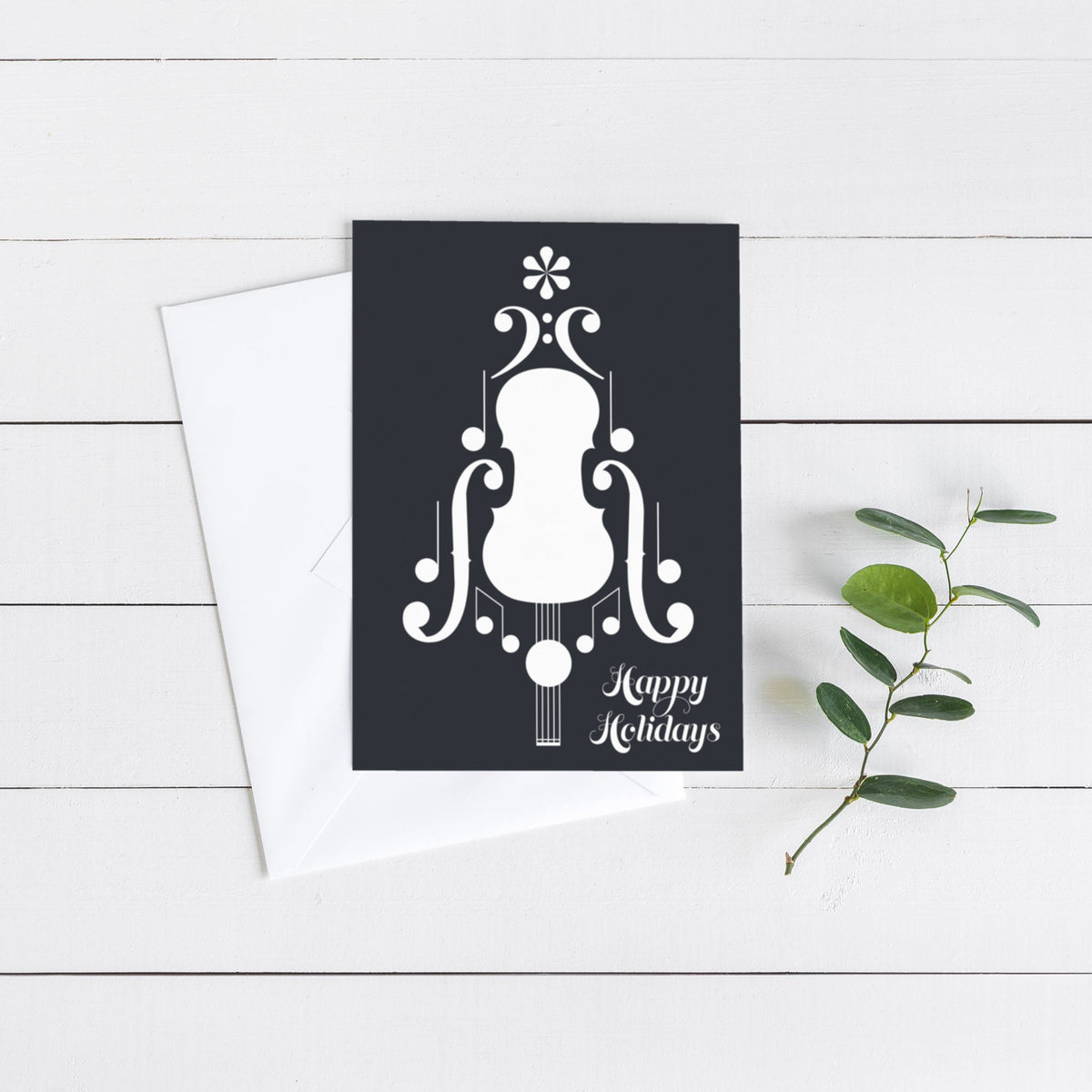Music-themed holiday cards with a stylized string instrument body assembled from bass clefs, eighth notes, and noteheads.