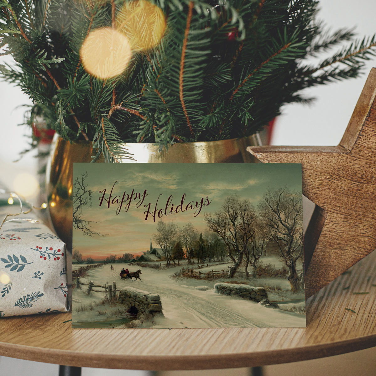 Set of 24 Christmas cards with a painting-style winter landscape and "Happy Holidays" in calligraphic script.