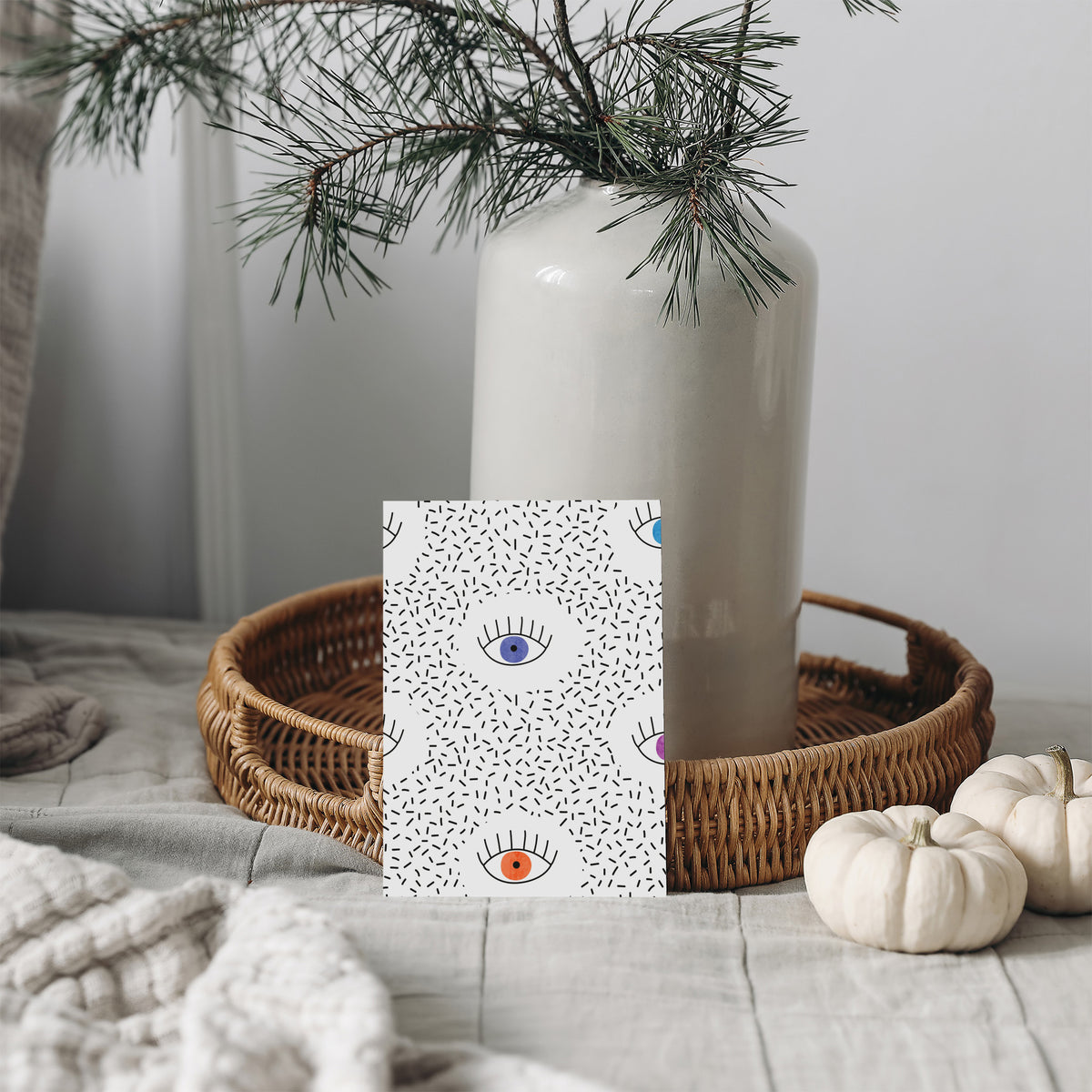 Card stationery set with graphic illustrated eyes and scattered black marks on a white background.