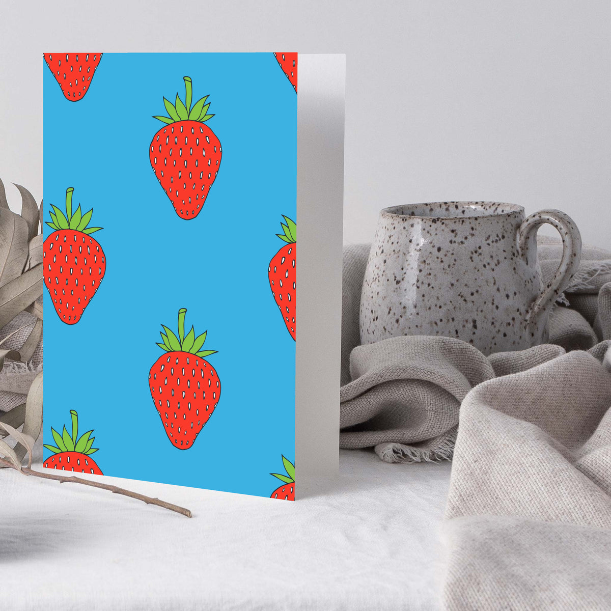 Blank notecards with bold illustrated strawberries on assorted colored backgrounds.