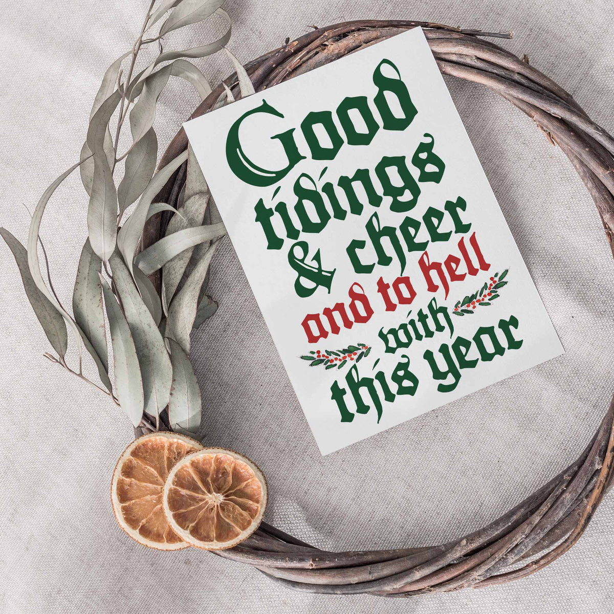 Box of 24 matching holiday cards featuring blackletter display text in dark green and red on white.