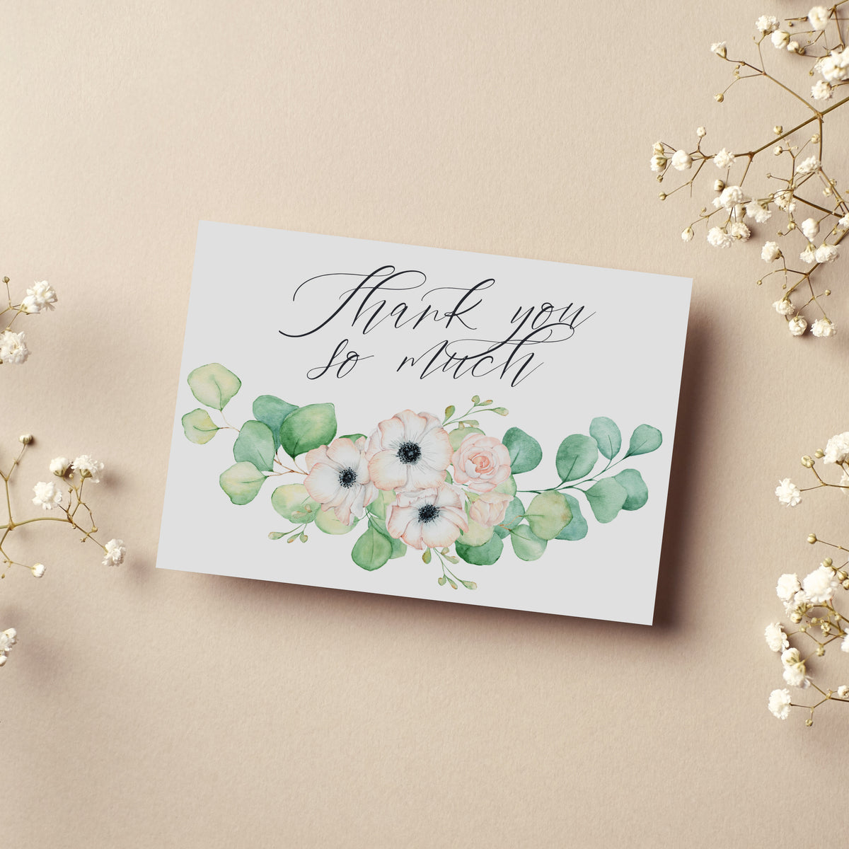 Boxed thank you card set with centered script text and watercolor botanical artwork.