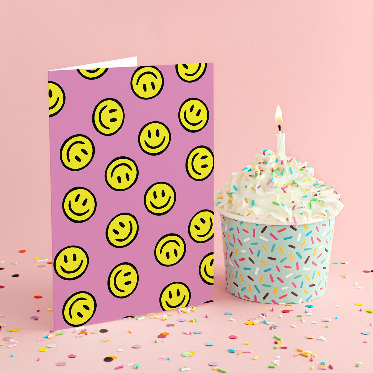 Boxed set of 24 cards with evenly spaced yellow smiley faces on a pink ground.