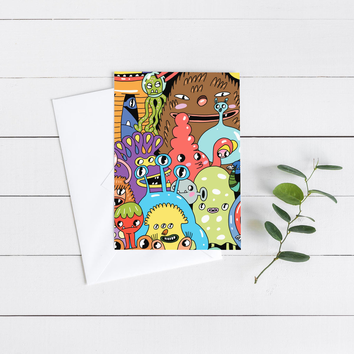 Pack of 24 greeting cards illustrated with whimsical cartoon monsters in blue, yellow, pink, green, and orange.
