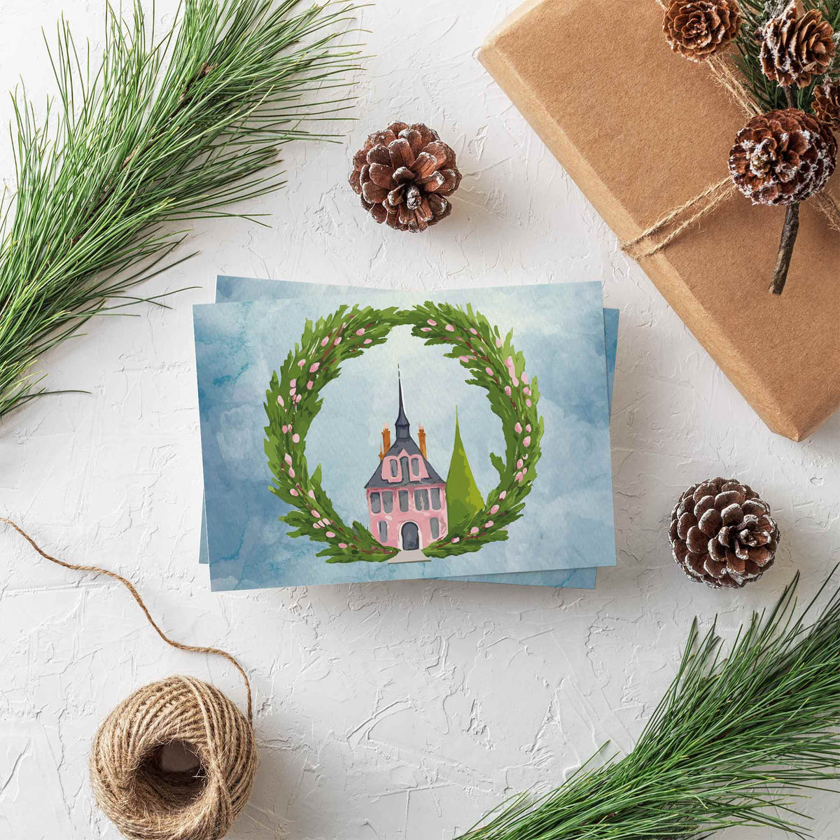 Two-design card set: pink house with slate-gray roof and spire, set against a blue watercolor background.