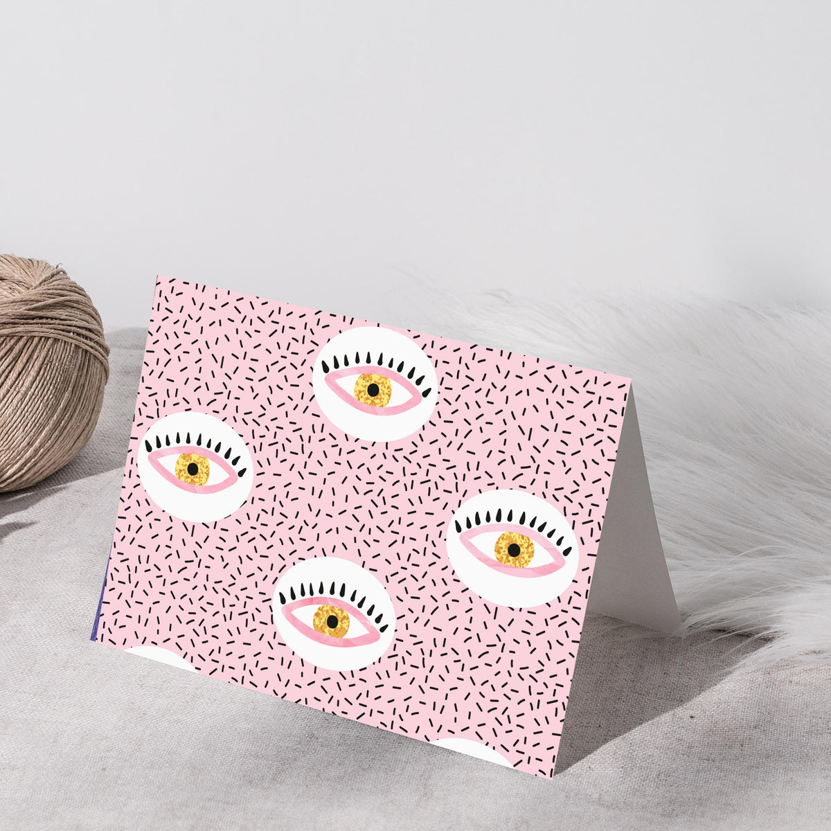 Card stationery set featuring two all-over eye patterns on pink and white backgrounds.