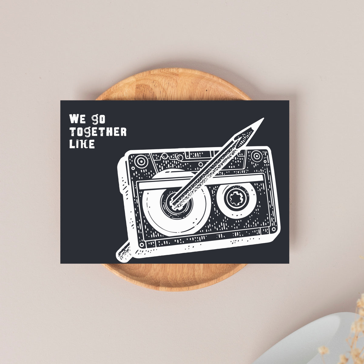 Card set, single design: black background, white line-art cassette and pencil, distressed block lettering upper left.