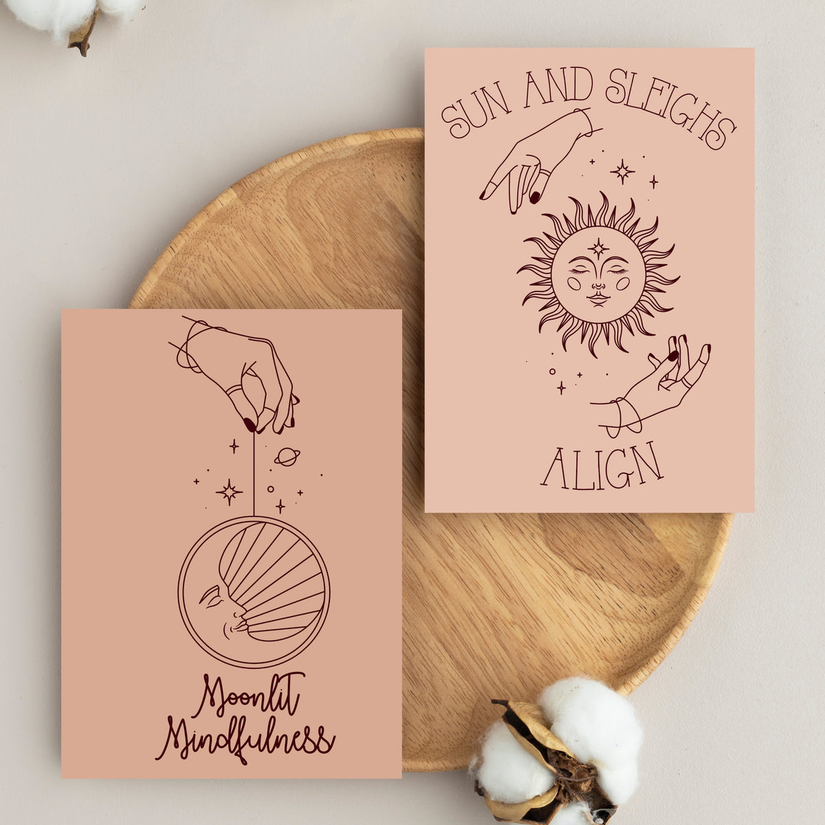 Card holiday set with astrological and celestial symbols rendered in dark brown linework on beige and blush backgrounds.