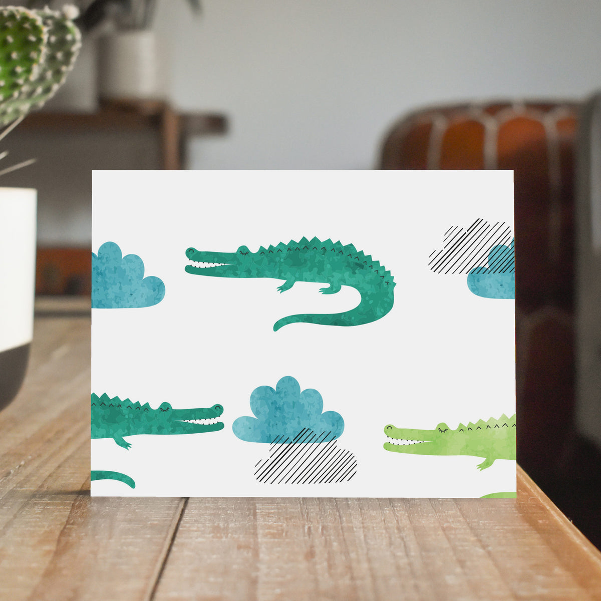 Cards in two designs showing repeat-pattern crocodilian figures at varied scales and orientations.
