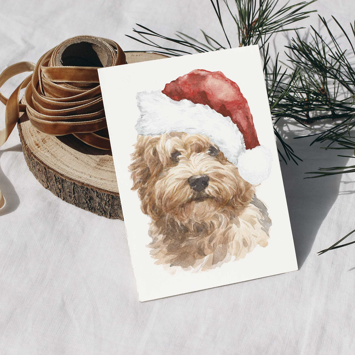 Christmas card set, one design repeated, showing a honey-colored labradoodle in a conical Santa hat.