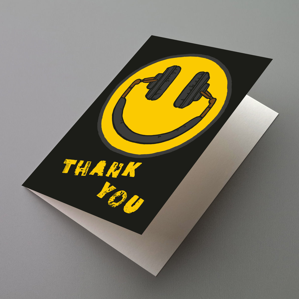 Black thank you cards printed with a large yellow smiley face icon and all-caps distressed lettering.