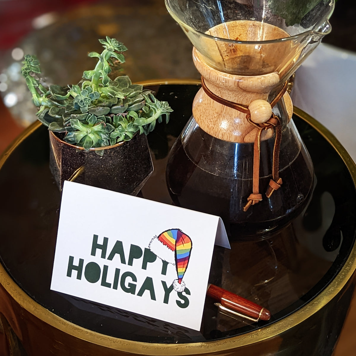 Blank note cards with white backgrounds; designs include rainbow Christmas trees and pride flag imagery.