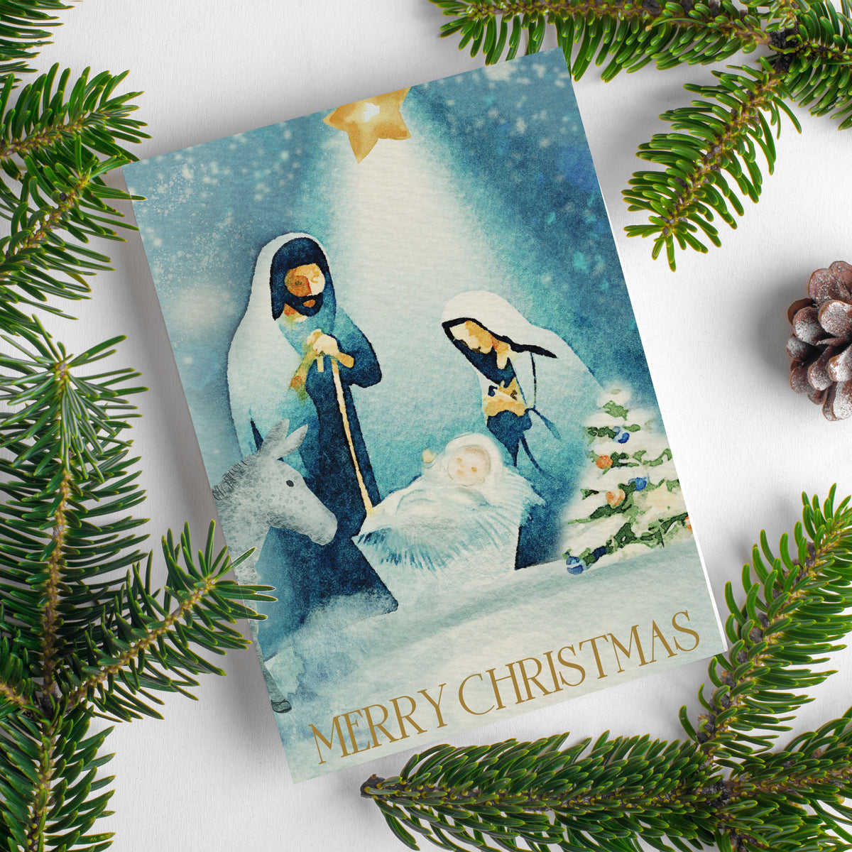 Christmas card set, one design, deep blue night-sky background with falling snow and gold star above nativity.