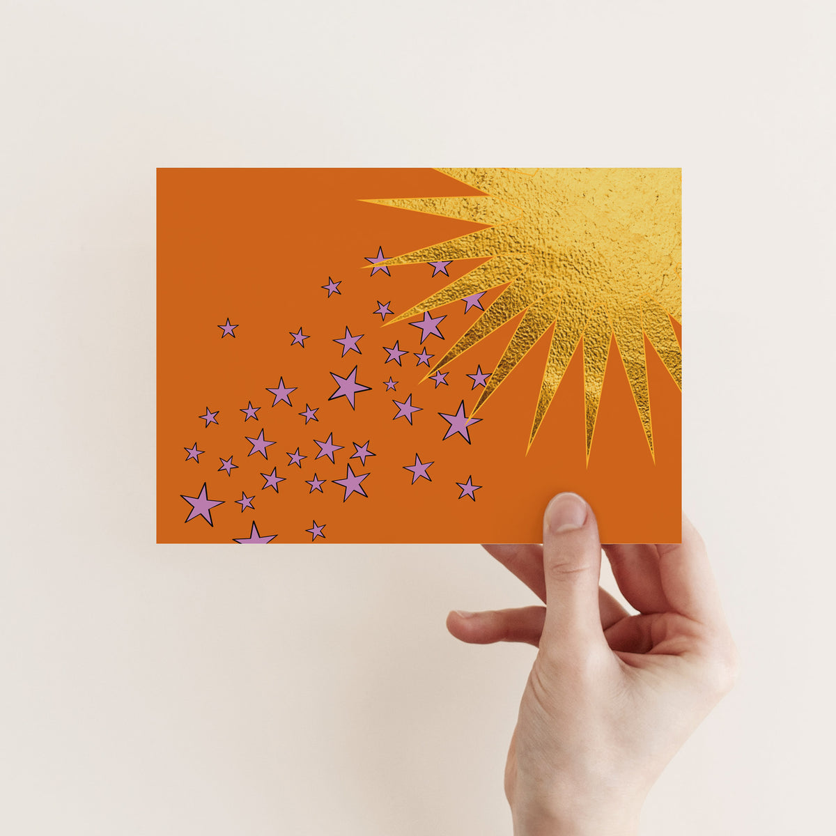 Blank cards with gold-colored shooting stars, sunbursts, and cloud graphics on varied colorful backgrounds.