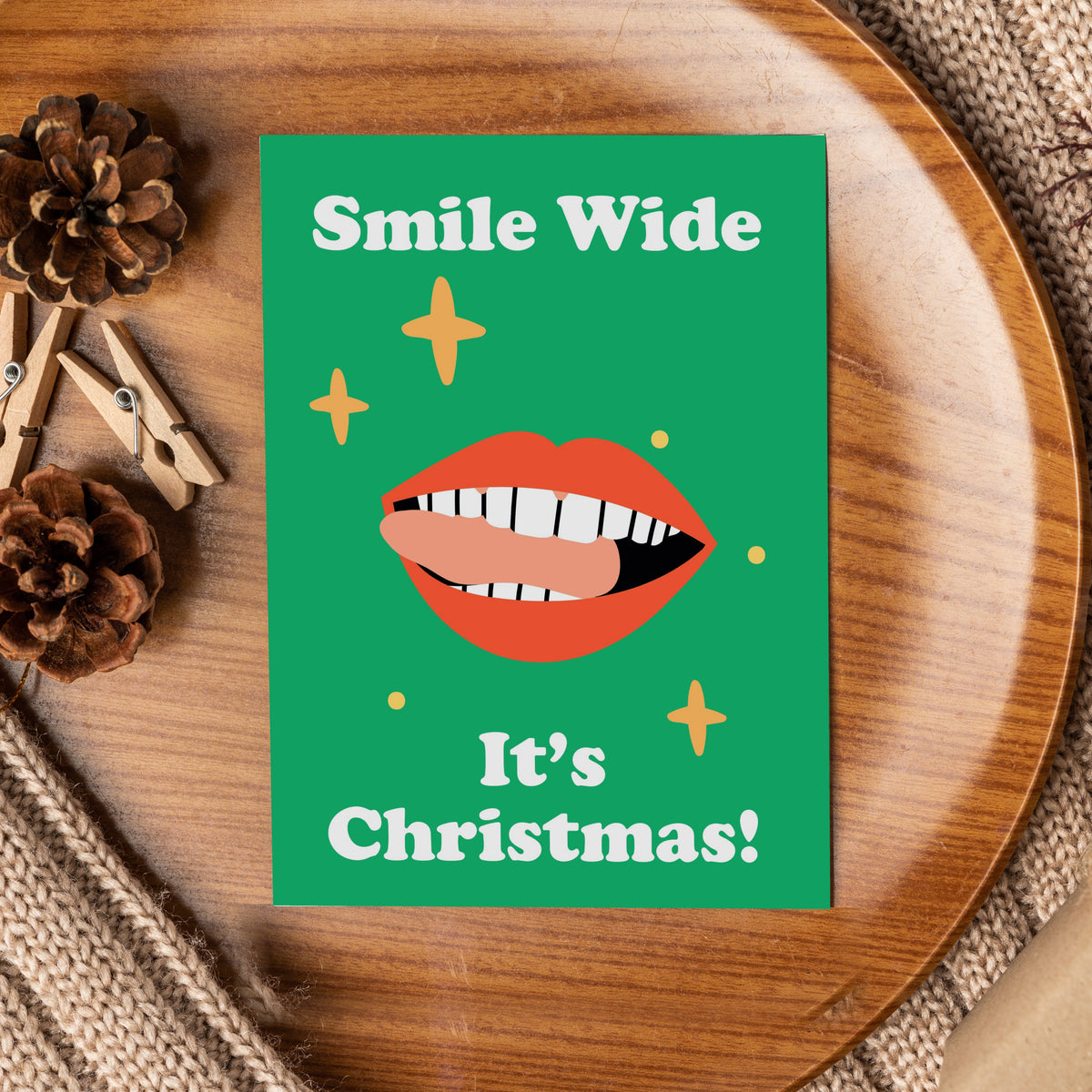 Christmas cards with dental illustrations including colorful toothbrushes on red-orange and a toothpaste tube on peach.