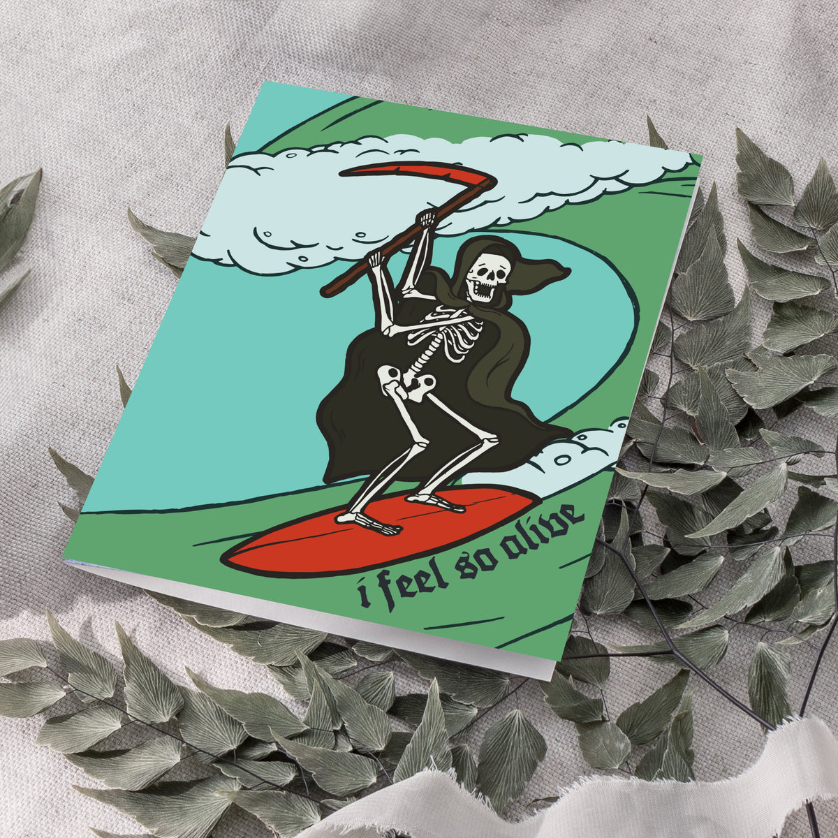 Dark humor card set, 24 cards, with outlined skeleton in black cloak surfing on a bold green wave.