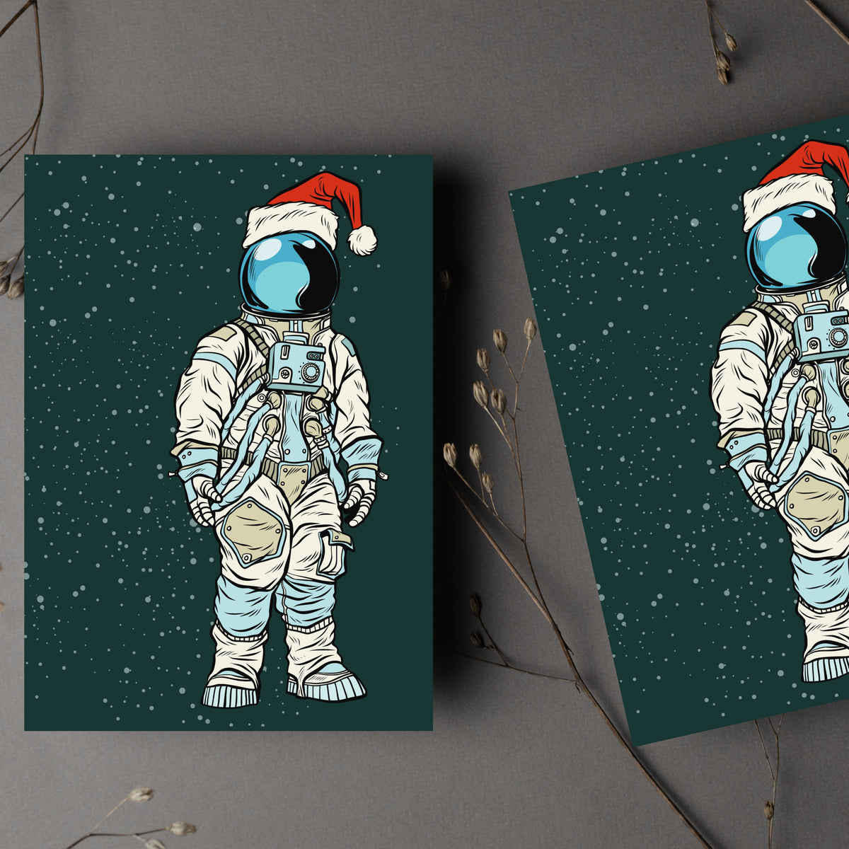 Comic-style astronaut Christmas card, dark green background with scattered stars, red Santa hat detail.