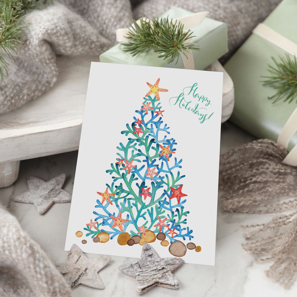Pack of 24 cards with two designs: coral tree illustration with "Happy Holidays!" in red or green brush script.