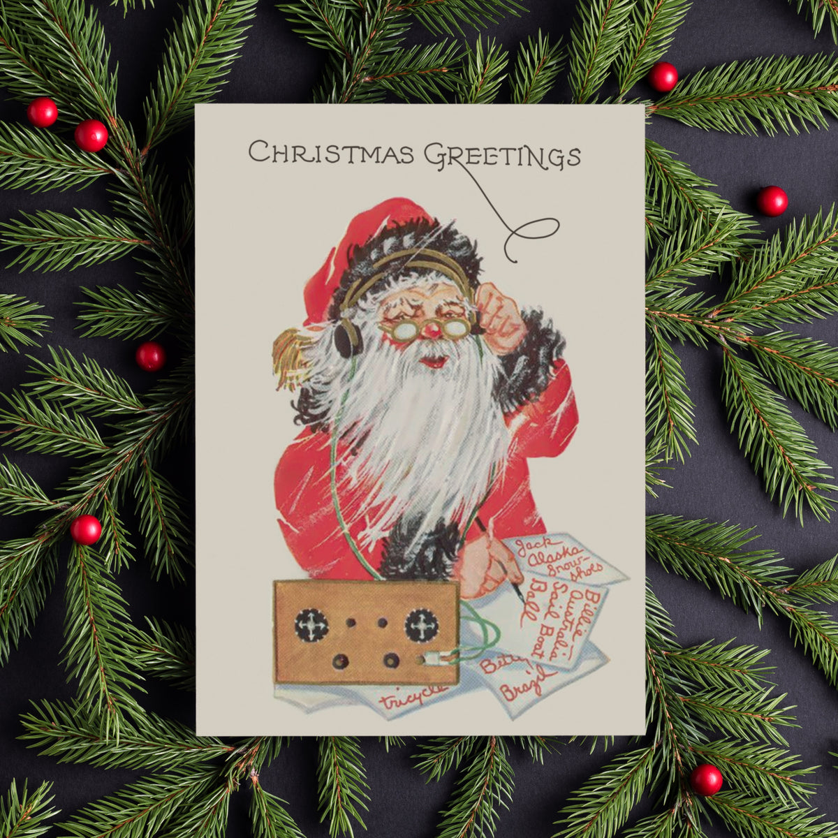 Christmas cards printed with "Christmas Greetings" in script lettering above a centered Santa figure.
