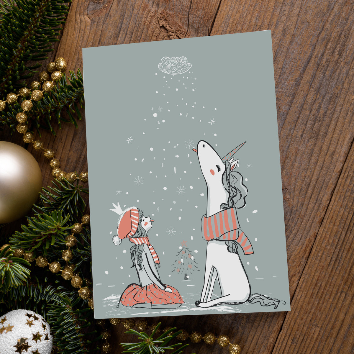 Set of 24 identical cards, winter scene with a girl and unicorn seated in snow beneath falling snowflakes.