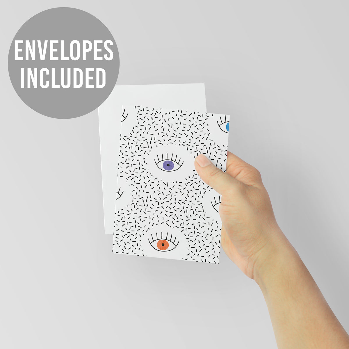 Notecard set printed with a repeating pattern of colorful illustrated eyes and black linework details.