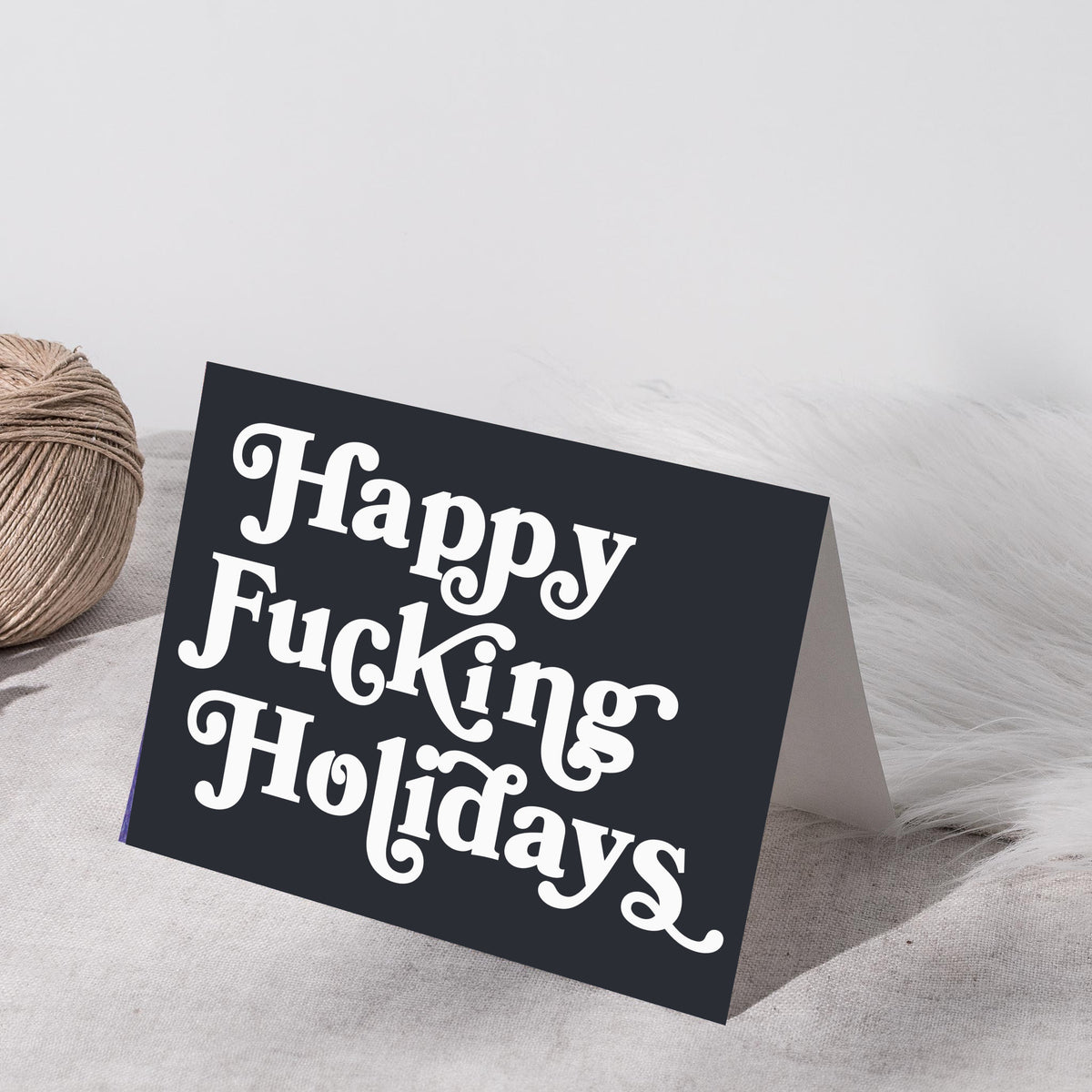 Set of 24 landscape-format Christmas cards in two text-only designs with swash capital serif typography.