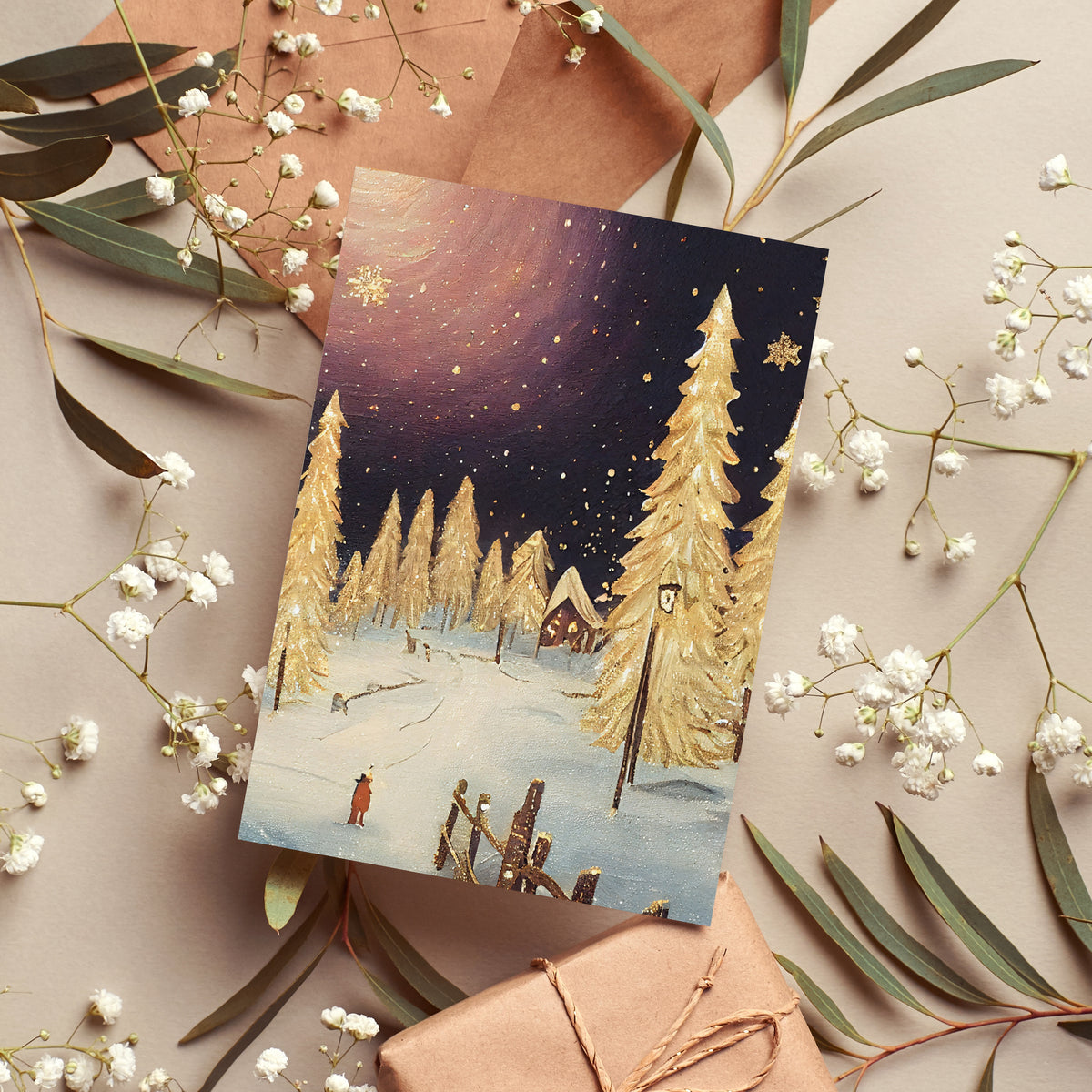 Box of 24 Christmas cards showing gold-colored trees, lamp posts, and snow-covered village scenes.