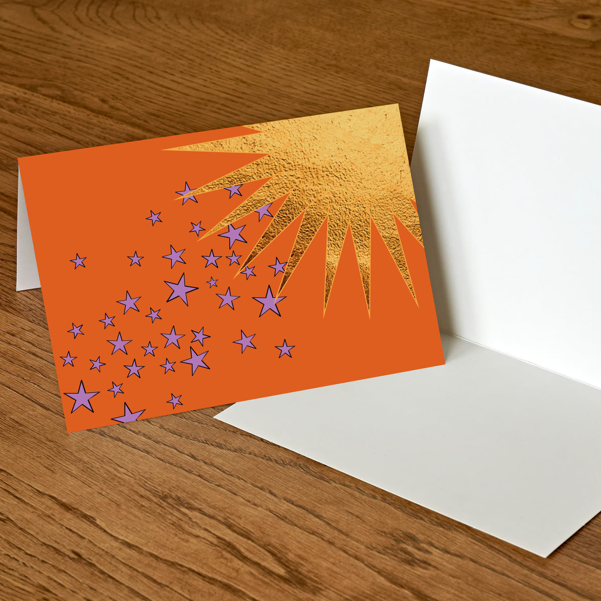 Set of 24 celestial notecards with abstract sun, rainbow, and star illustrations in bright hues.