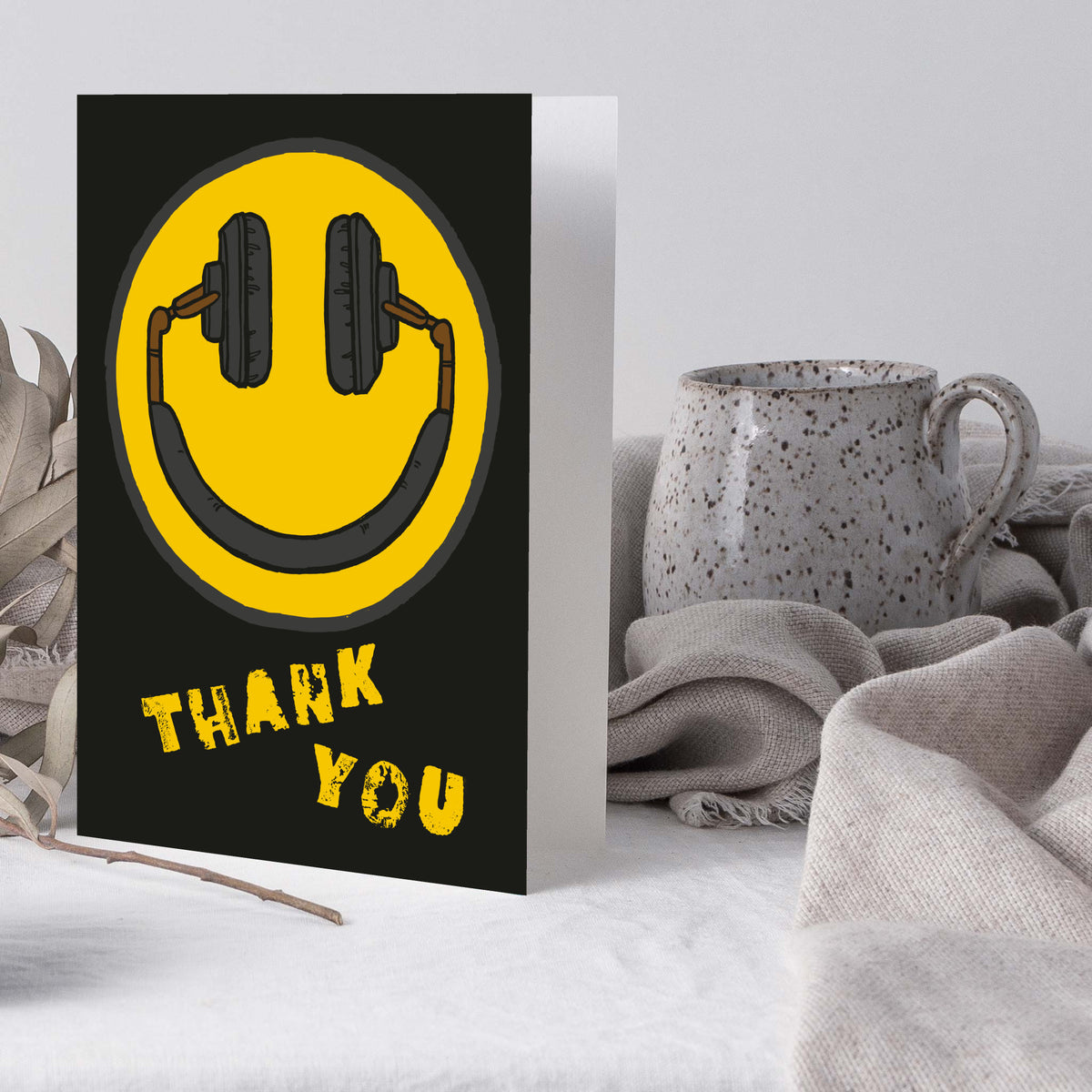 Boxed set of 24 cards with a flat graphic smiley face wearing headphones and "THANK YOU" below.
