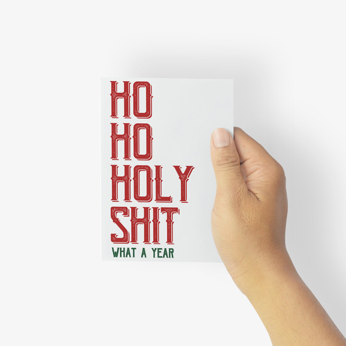 White holiday card with left-aligned distressed red capitals and a dark green secondary line, boxed set of 24.