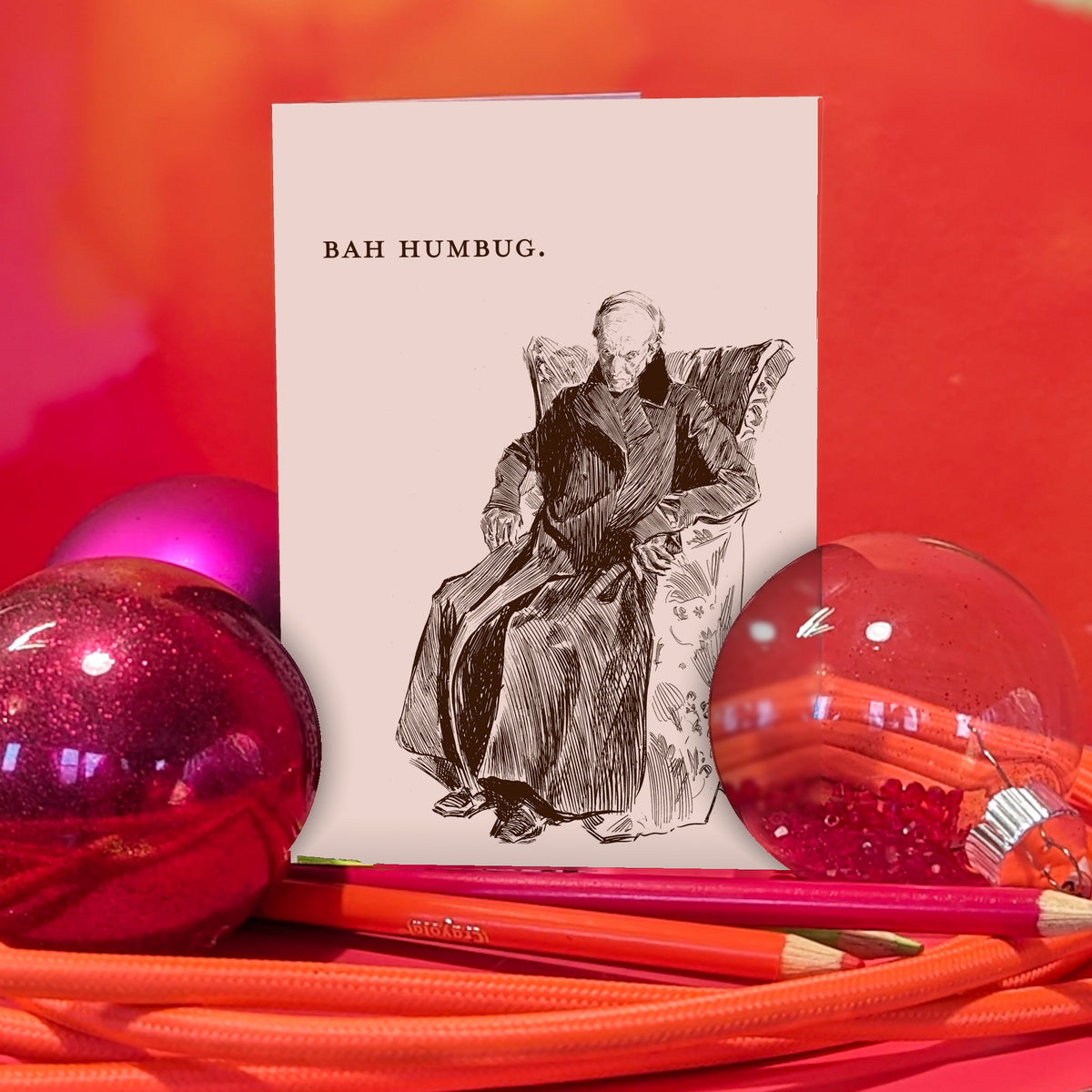 Christmas card with pen-and-ink drawing of a downturned, coat-clad old man gripping a wingback chair arm, 24-card pack.