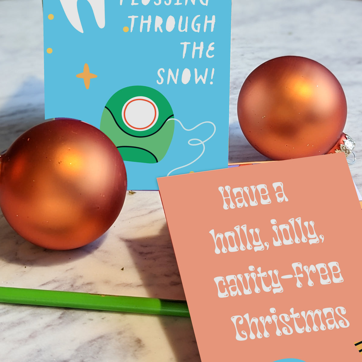 Holiday card set with a green-background open-mouth design reading "Smile Wide It's Christmas!" and sparkle accents.