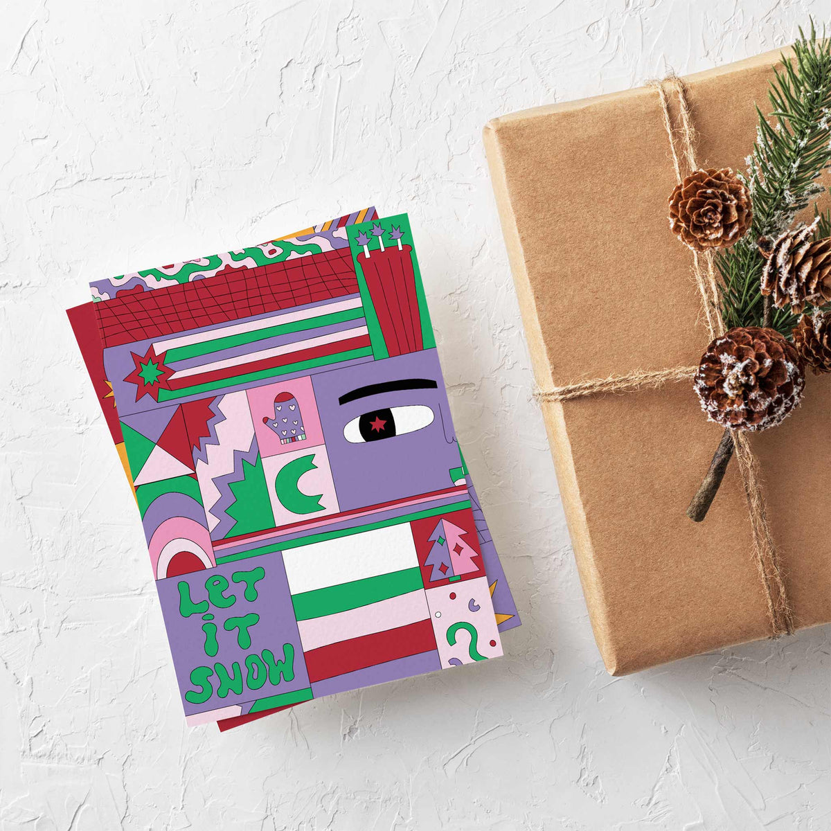 Holiday card set with four designs, each showing illustrated panels including mittens, stockings, starbursts, and rainbows.