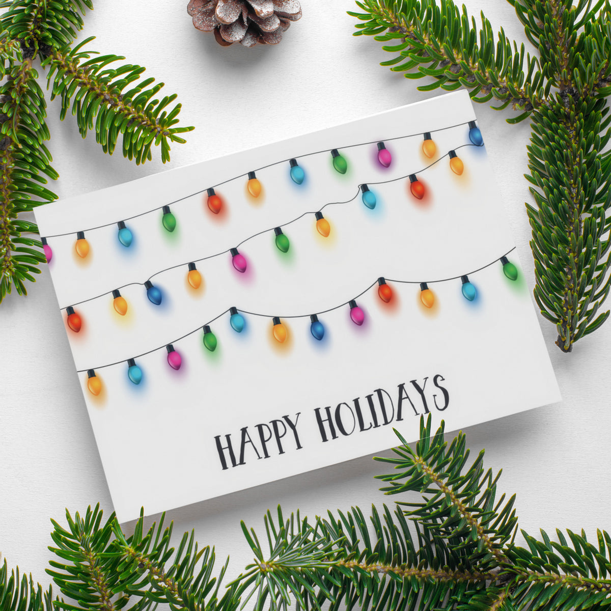 String light bulbs with soft color halos on white background; "HAPPY HOLIDAYS" in all-caps below.