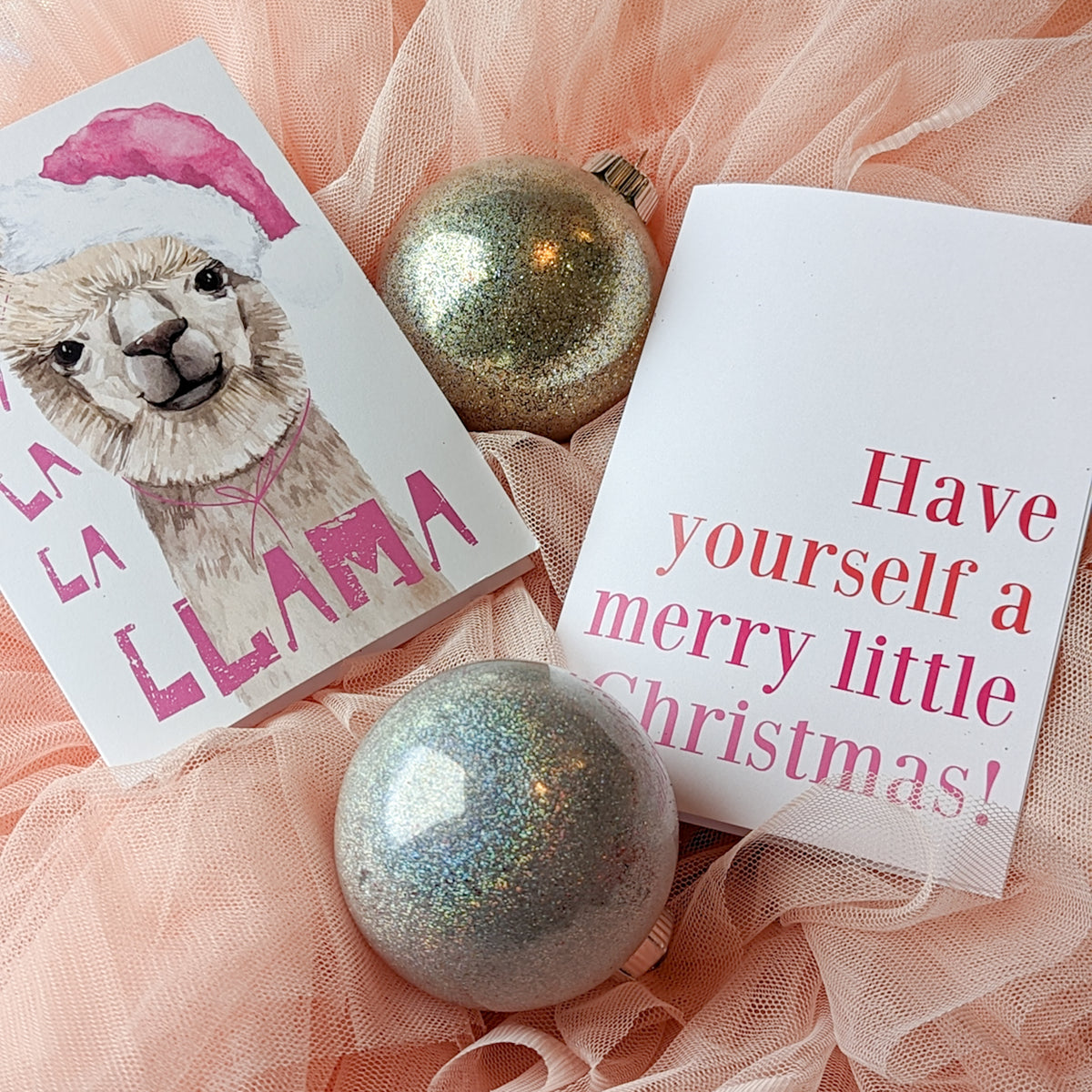 Christmas cards featuring illustrated animals in Santa hats alongside holiday phrases in script and display lettering.