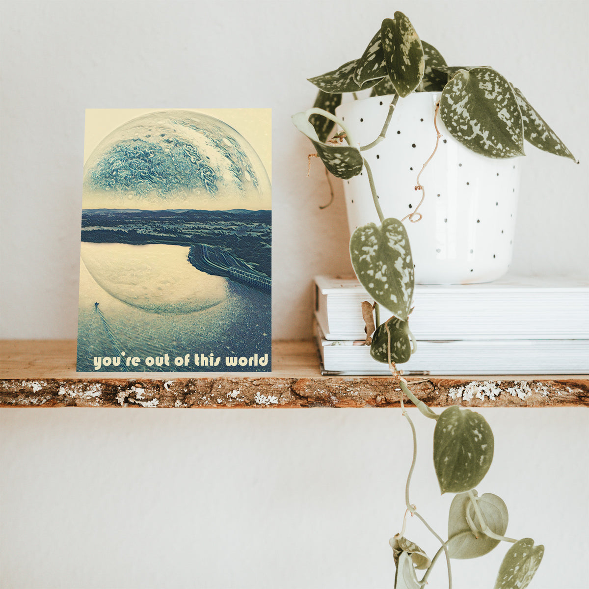 Cool-toned card illustration with a cream and gray planetary sphere occupying the upper half of the card face.