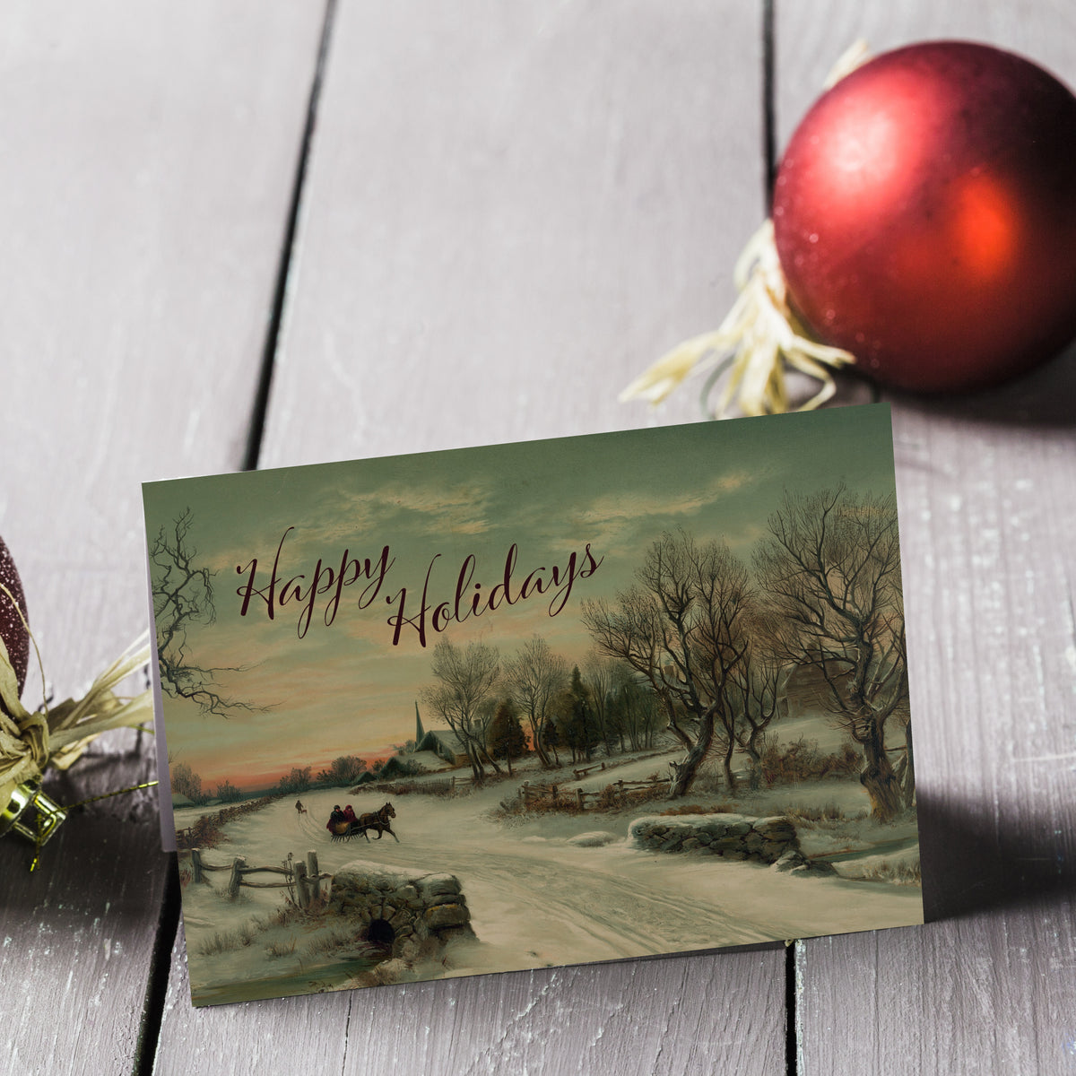 Identical holiday cards, full-bleed chromolithograph winter scene, dark maroon script text in upper left.