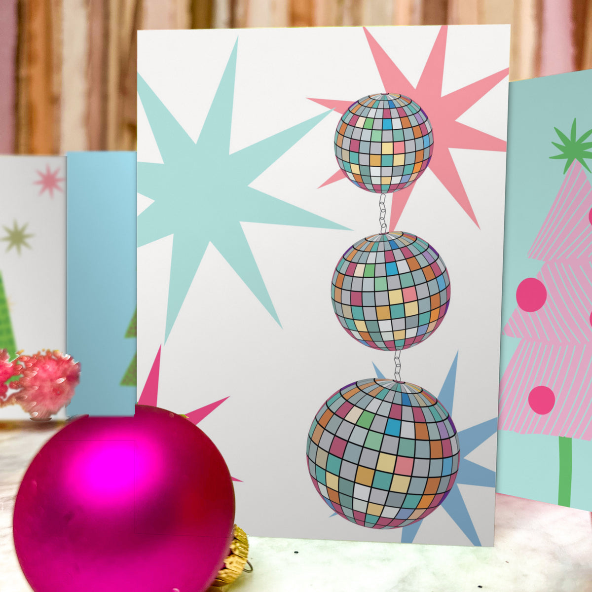 Christmas cards in six illustrated designs featuring disco balls, ornaments, and striped or dotted trees.