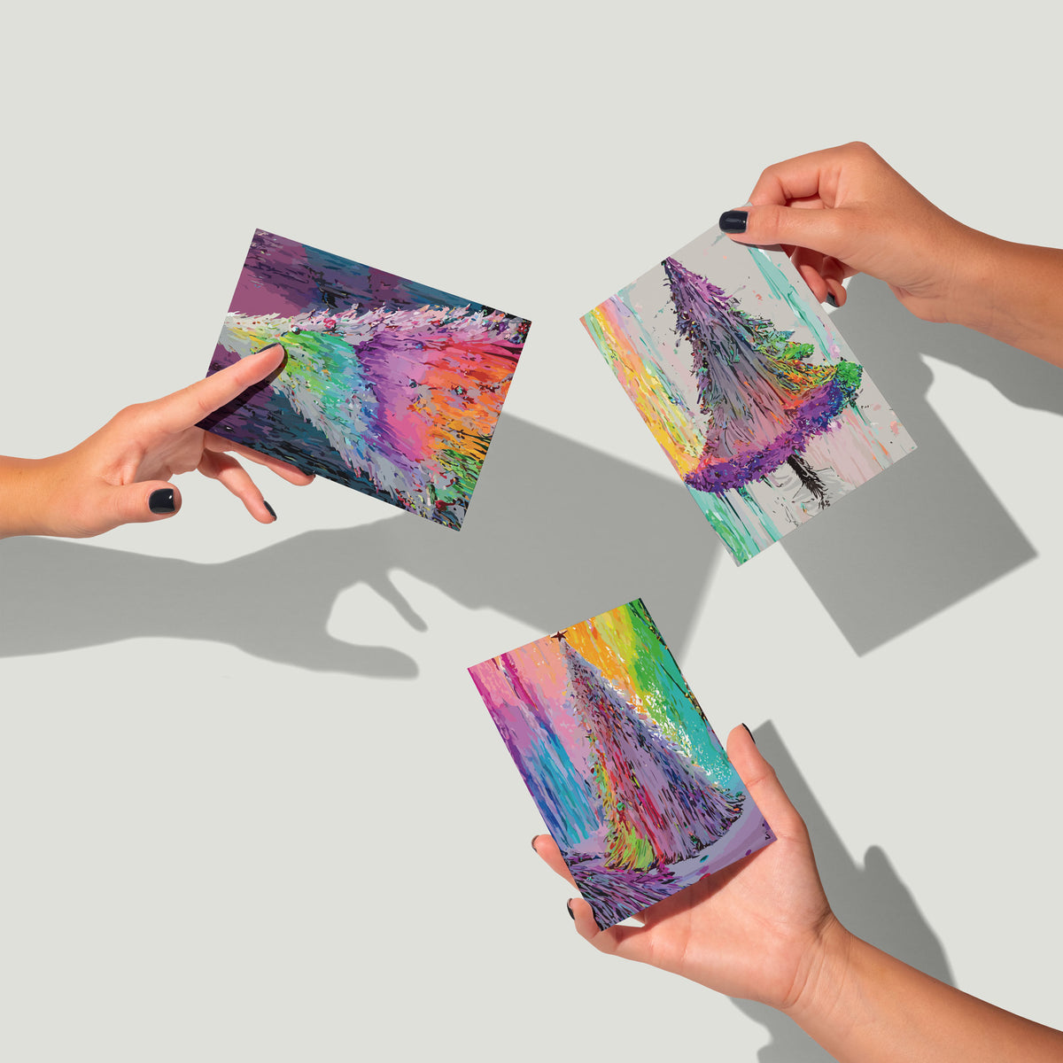 Brushstroke Christmas trees in tones of teal, purple, pink and green on multicolor banded cards.