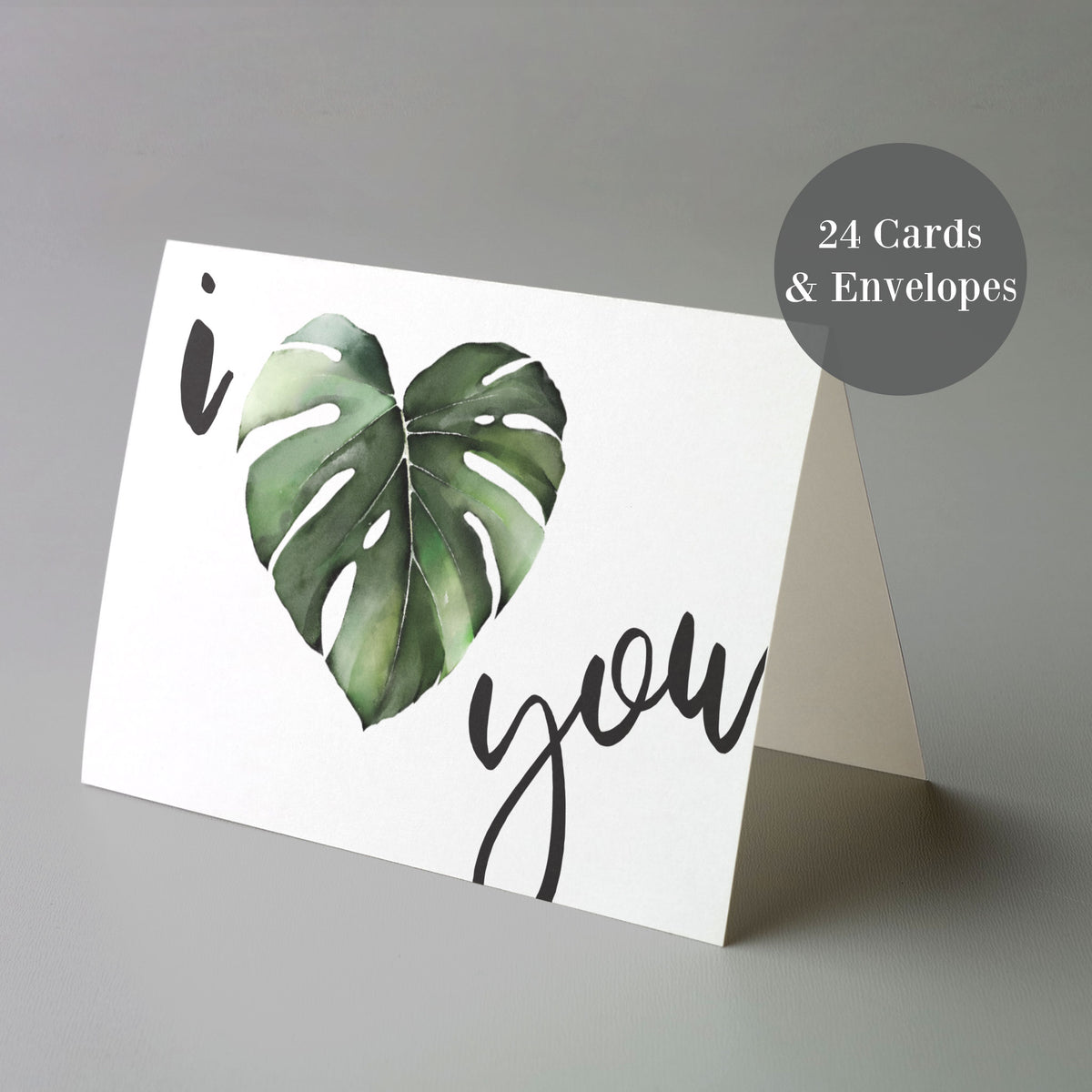 Heart-shaped monstera leaf illustration in green with "i" and "you" in handwritten-style lowercase lettering.